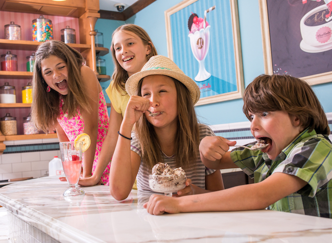 Kids enjoy ice cream at the counter at Chocolate Foundry